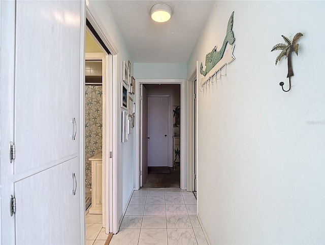 4360 Tahitian Gardens Cir Unit H, Holiday, FL 34691 - hallway featuring light marble finish floors and baseboards
