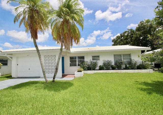 3643 Mainlands Blvd N, Pinellas Park, FL 33782 - ranch-style home featuring a garage, stucco siding, a front lawn, and concrete driveway
