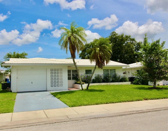 3643 Mainlands Blvd N, Pinellas Park, FL 33782 - single story home featuring an attached garage, a tile roof, concrete driveway, a front lawn, and stucco siding