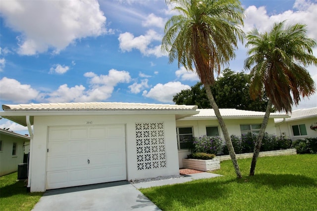 3643 Mainlands Blvd N, Pinellas Park, FL 33782 - ranch-style house with a garage, a front yard, stucco siding, and concrete driveway