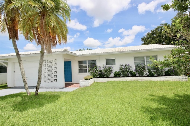 3643 Mainlands Blvd N, Pinellas Park, FL 33782 - ranch-style house featuring a garage, a front yard, stucco siding, and driveway