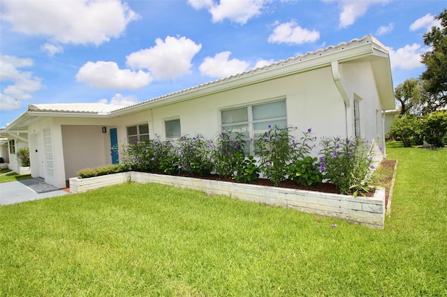 3643 Mainlands Blvd N, Pinellas Park, FL 33782 - view of home's exterior with a yard and stucco siding
