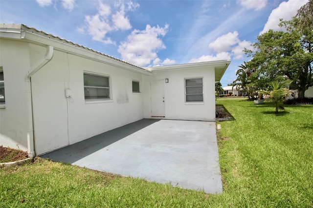 3643 Mainlands Blvd N, Pinellas Park, FL 33782 - back of house featuring a lawn, a patio area, and stucco siding