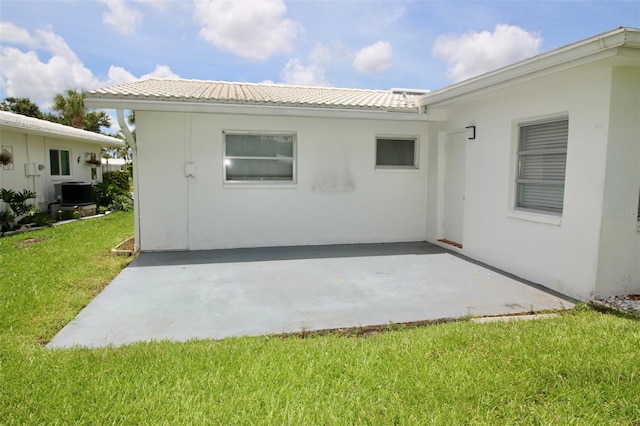 3643 Mainlands Blvd N, Pinellas Park, FL 33782 - rear view of property with a patio, a lawn, and stucco siding