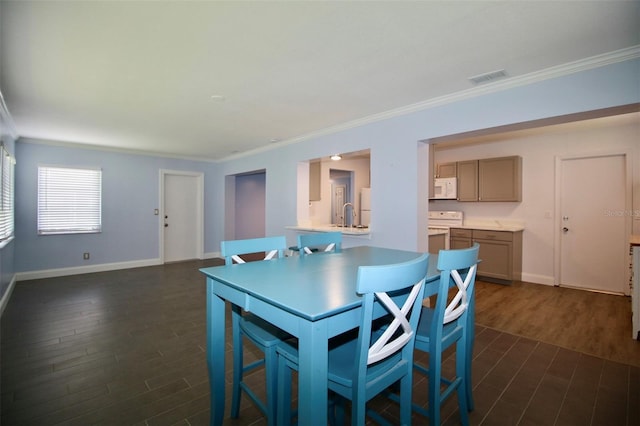 3643 Mainlands Blvd N, Pinellas Park, FL 33782 - dining space with crown molding and dark wood-style flooring