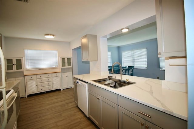 3643 Mainlands Blvd N, Pinellas Park, FL 33782 - kitchen with white appliances, gray cabinetry, dark wood-style flooring, and light stone countertops