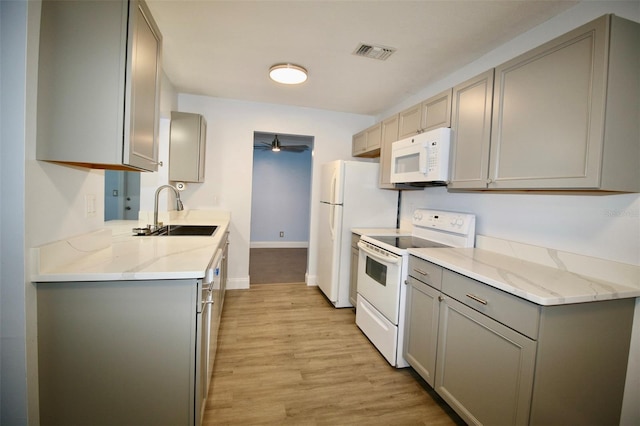 3643 Mainlands Blvd N, Pinellas Park, FL 33782 - kitchen featuring white appliances, gray cabinets, ceiling fan, and light wood finished floors