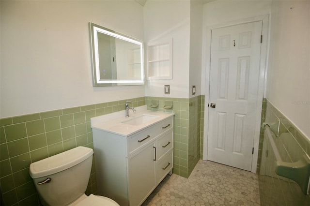 3643 Mainlands Blvd N, Pinellas Park, FL 33782 - bathroom featuring tile walls, vanity, a wainscoted wall, and tile patterned flooring