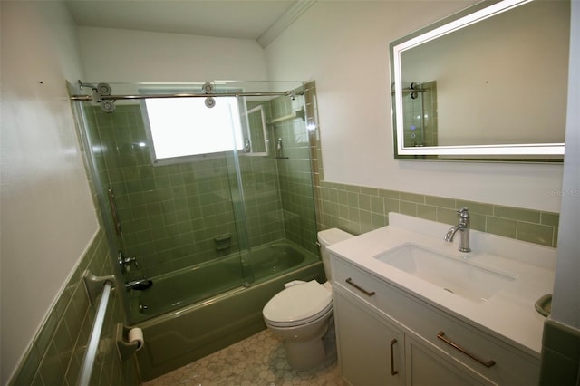 3643 Mainlands Blvd N, Pinellas Park, FL 33782 - bathroom with tile walls, vanity, enclosed tub / shower combo, and a wainscoted wall