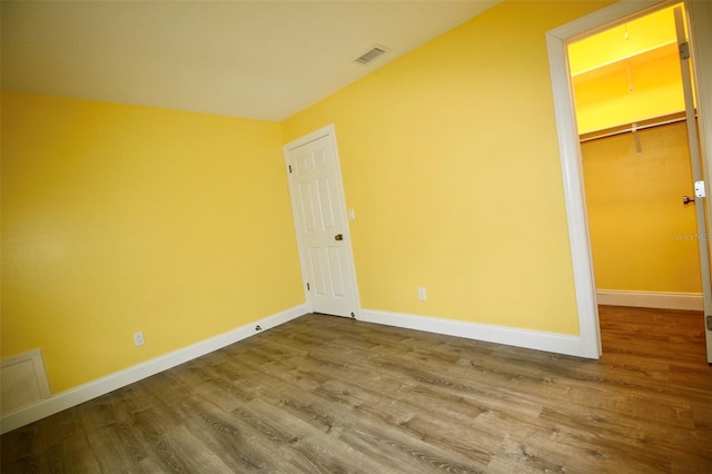 3643 Mainlands Blvd N, Pinellas Park, FL 33782 - unfurnished bedroom with wood finished floors, a spacious closet, and a closet