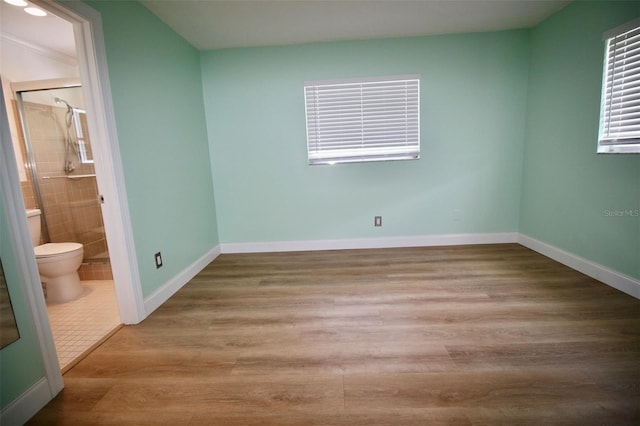 3643 Mainlands Blvd N, Pinellas Park, FL 33782 - unfurnished bedroom featuring wood finished floors and ensuite bath