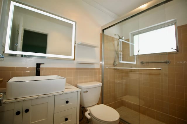 3643 Mainlands Blvd N, Pinellas Park, FL 33782 - full bathroom featuring a shower stall, vanity, tile walls, and wainscoting