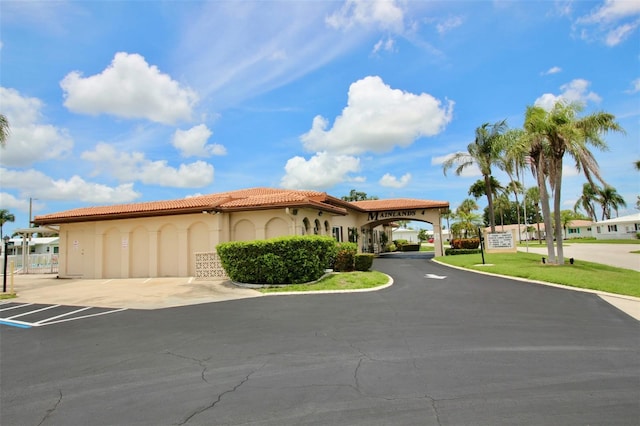 3643 Mainlands Blvd N, Pinellas Park, FL 33782 - mediterranean / spanish home with stucco siding, a tiled roof, and uncovered parking