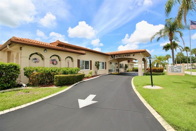 3643 Mainlands Blvd N, Pinellas Park, FL 33782 - mediterranean / spanish-style home featuring stucco siding, a front yard, and a tile roof
