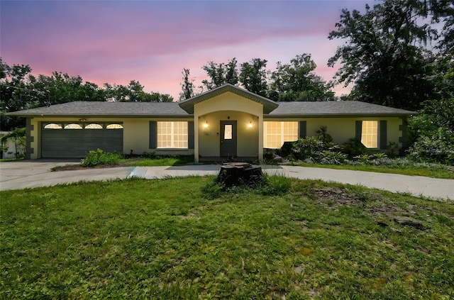 4514 John Moore Rd, Brandon, FL 33511 - single story home with concrete driveway, an attached garage, stucco siding, and a front yard
