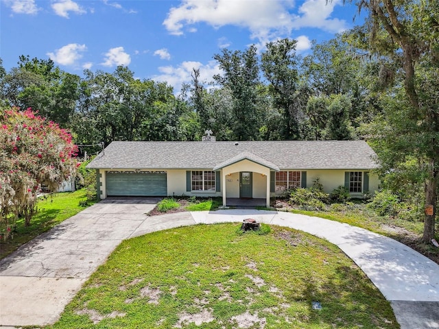 4514 John Moore Rd, Brandon, FL 33511 - view of front of property featuring a garage, driveway, a front yard, and stucco siding