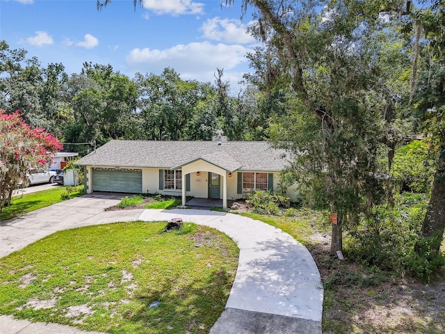 4514 John Moore Rd, Brandon, FL 33511 - ranch-style home with driveway, an attached garage, a front yard, and stucco siding