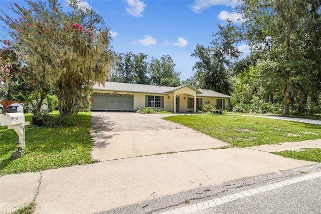 4514 John Moore Rd, Brandon, FL 33511 - ranch-style home with a garage, a front yard, concrete driveway, and stucco siding