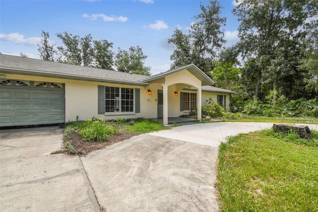 4514 John Moore Rd, Brandon, FL 33511 - ranch-style home with concrete driveway, stucco siding, and an attached garage