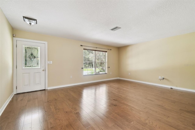 4514 John Moore Rd, Brandon, FL 33511 - foyer entrance featuring a textured ceiling and wood finished floors