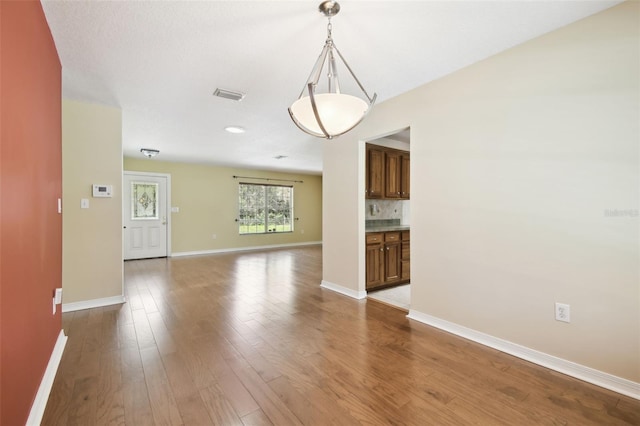 4514 John Moore Rd, Brandon, FL 33511 - unfurnished living room featuring baseboards and wood finished floors