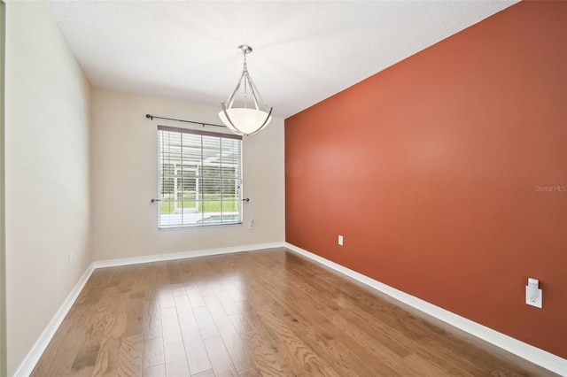 4514 John Moore Rd, Brandon, FL 33511 - spare room featuring wood finished floors and baseboards