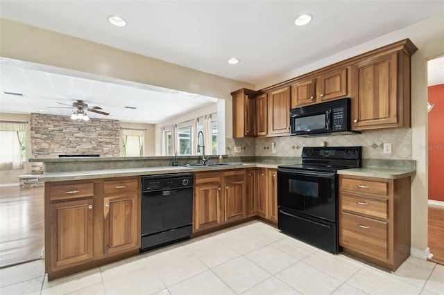 4514 John Moore Rd, Brandon, FL 33511 - kitchen with black appliances, a peninsula, brown cabinetry, ceiling fan, and plenty of natural light