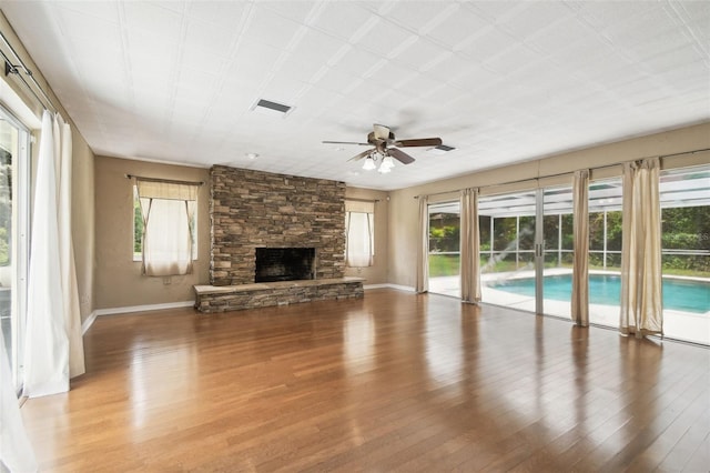 4514 John Moore Rd, Brandon, FL 33511 - unfurnished living room featuring healthy amount of natural light, wood finished floors, and a ceiling fan