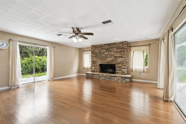 4514 John Moore Rd, Brandon, FL 33511 - unfurnished living room with healthy amount of natural light, wood finished floors, and a fireplace