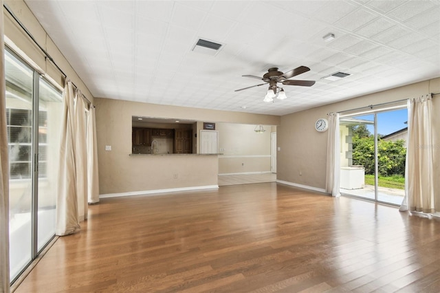 4514 John Moore Rd, Brandon, FL 33511 - unfurnished living room with wood finished floors and a ceiling fan
