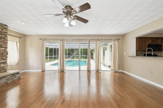 4514 John Moore Rd, Brandon, FL 33511 - unfurnished living room featuring wood finished floors and ceiling fan
