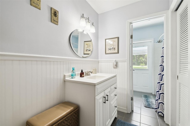 4514 John Moore Rd, Brandon, FL 33511 - bathroom with vanity, tile patterned flooring, a wainscoted wall, and a shower