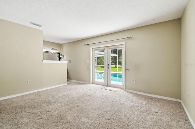 4514 John Moore Rd, Brandon, FL 33511 - spare room with french doors, carpet, and a textured ceiling