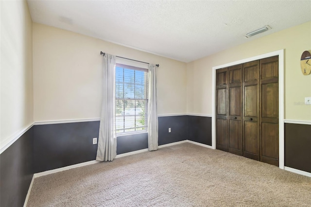 4514 John Moore Rd, Brandon, FL 33511 - unfurnished bedroom featuring carpet, a textured ceiling, and a closet