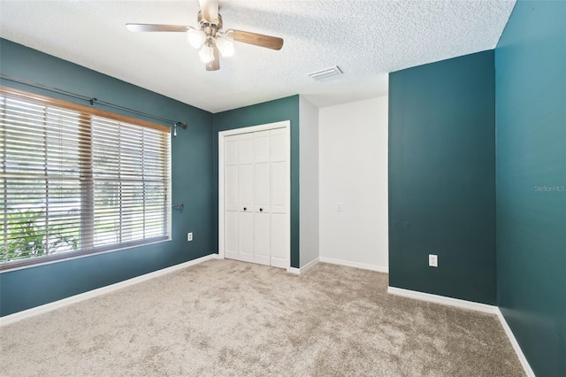 4514 John Moore Rd, Brandon, FL 33511 - unfurnished bedroom with carpet, a closet, a textured ceiling, and a ceiling fan
