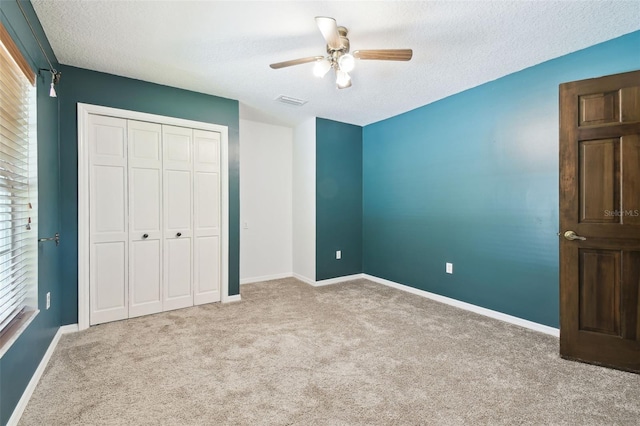 4514 John Moore Rd, Brandon, FL 33511 - unfurnished bedroom featuring a textured ceiling, carpet, a closet, and a ceiling fan