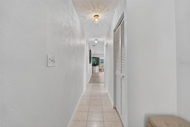 7051 Bright Creek Dr Unit 6, Sarasota, FL 34231 - corridor featuring light tile patterned flooring and a textured ceiling