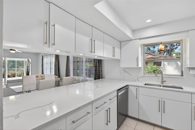 7051 Bright Creek Dr Unit 6, Sarasota, FL 34231 - kitchen with white cabinetry, dishwasher, light stone counters, recessed lighting, and light tile patterned floors