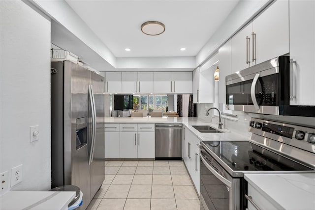 7051 Bright Creek Dr Unit 6, Sarasota, FL 34231 - kitchen with stainless steel appliances, white cabinetry, light tile patterned flooring, and recessed lighting