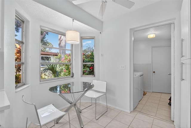 7051 Bright Creek Dr Unit 6, Sarasota, FL 34231 - dining room featuring separate washer and dryer, light tile patterned flooring, a textured ceiling, and a ceiling fan