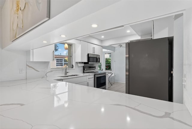 7051 Bright Creek Dr Unit 6, Sarasota, FL 34231 - kitchen with appliances with stainless steel finishes, healthy amount of natural light, light stone counters, and recessed lighting