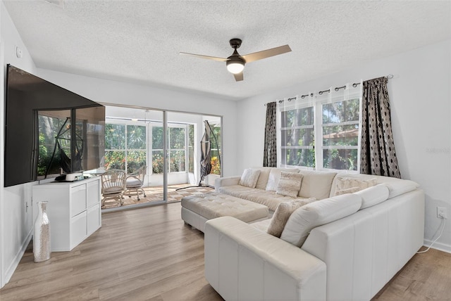7051 Bright Creek Dr Unit 6, Sarasota, FL 34231 - living area with a textured ceiling, a ceiling fan, and light wood-type flooring