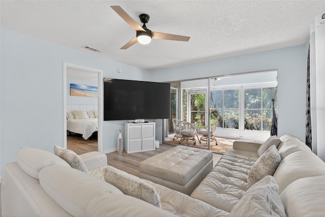 7051 Bright Creek Dr Unit 6, Sarasota, FL 34231 - living room featuring wood finished floors, a ceiling fan, and a textured ceiling