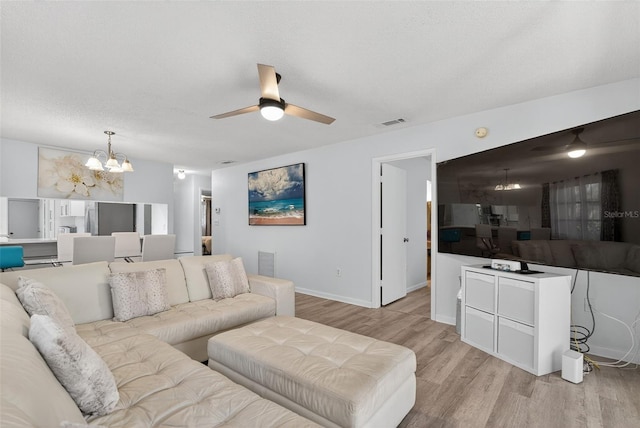 7051 Bright Creek Dr Unit 6, Sarasota, FL 34231 - living room featuring a chandelier, ceiling fan, and light wood-style floors