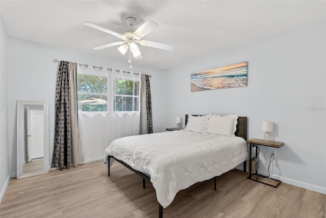7051 Bright Creek Dr Unit 6, Sarasota, FL 34231 - bedroom with light wood-style flooring, a textured ceiling, and ceiling fan