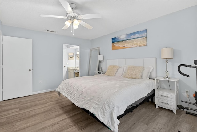 7051 Bright Creek Dr Unit 6, Sarasota, FL 34231 - bedroom with wood finished floors, ceiling fan, and ensuite bathroom
