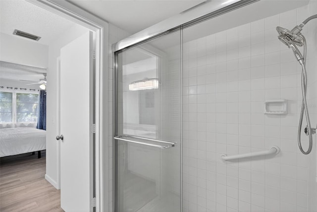 7051 Bright Creek Dr Unit 6, Sarasota, FL 34231 - ensuite bathroom with a stall shower, a ceiling fan, and wood finished floors