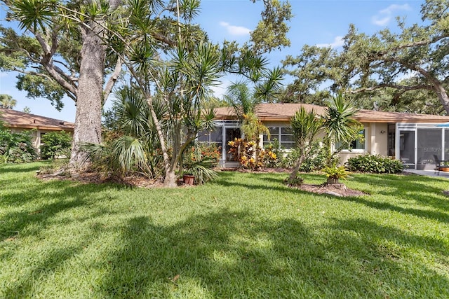 7051 Bright Creek Dr Unit 6, Sarasota, FL 34231 - view of front of house with a sunroom, a front yard, and stucco siding