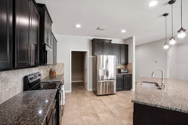 15206 Trinity Fall Way, Bradenton, FL 34212 - kitchen with stainless steel fridge with ice dispenser, range with electric cooktop, arched walkways, decorative backsplash, and dark stone counters