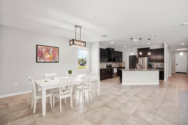 15206 Trinity Fall Way, Bradenton, FL 34212 - dining room featuring arched walkways, recessed lighting, and light tile patterned floors